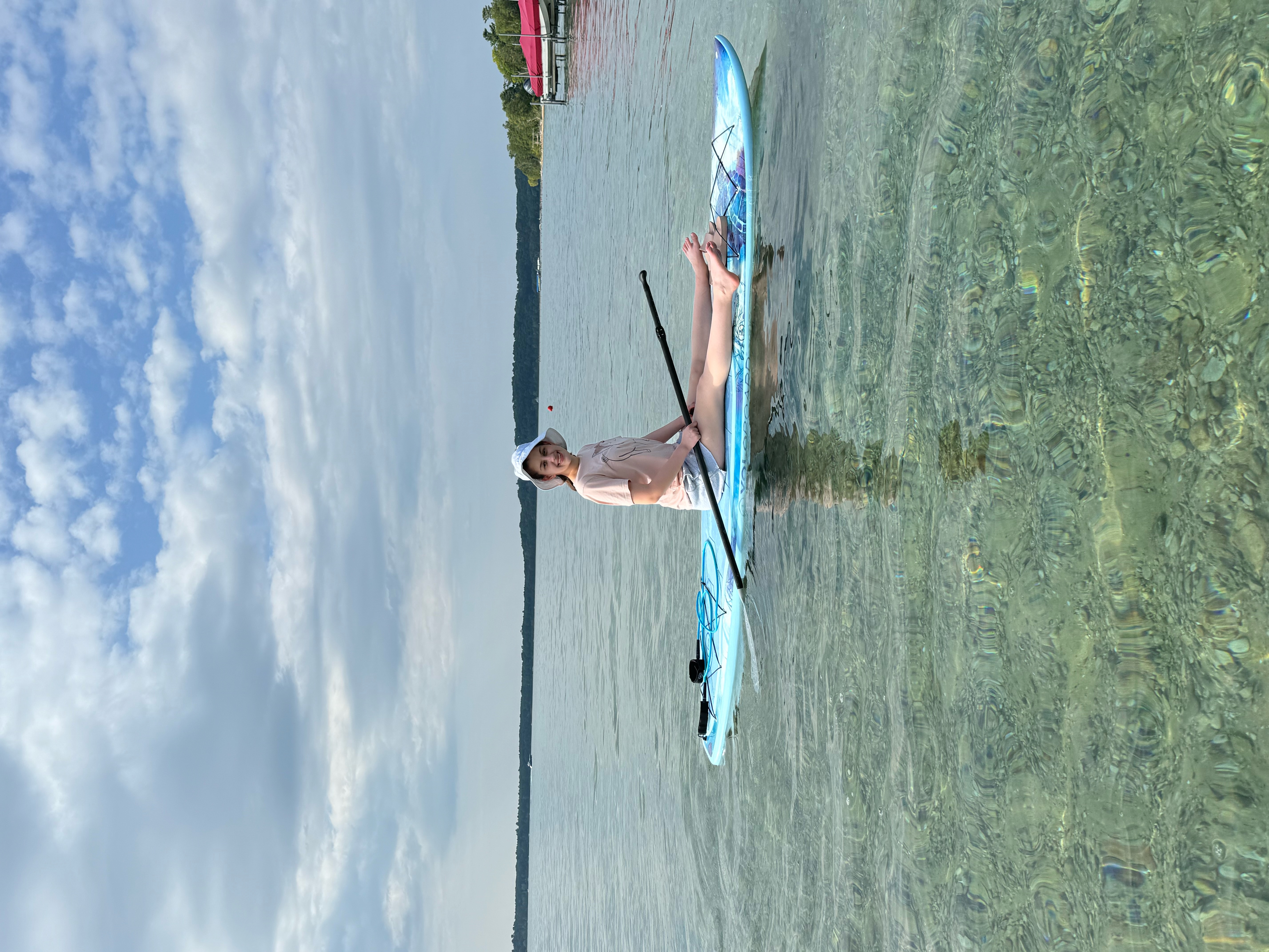 Adeline paddle boarding with a scoliosis brace