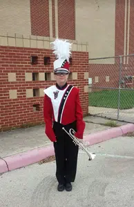 Starr in her band outfit with her trumpet, wearing her scoliosis brace underneath.