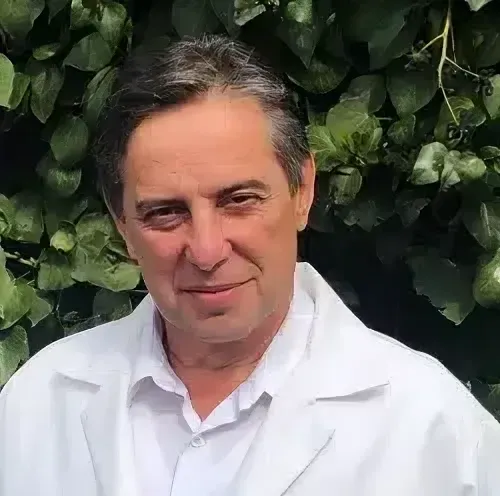 Portrait of Dr. Diaz with leaves in background outside Scoliosis Care Centers Clinic