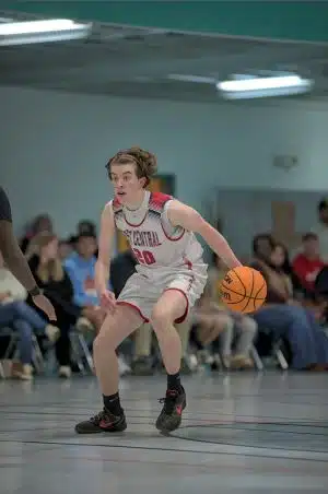 Child playing basketball with a scoliosis brace