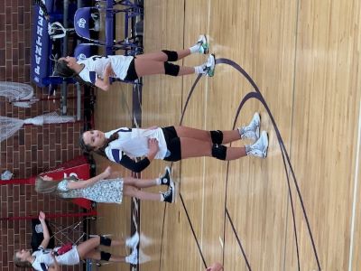 Child playing volleyball while wearing a scoliosis brace