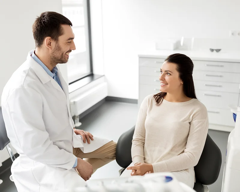 Woman consulting with doctor in office